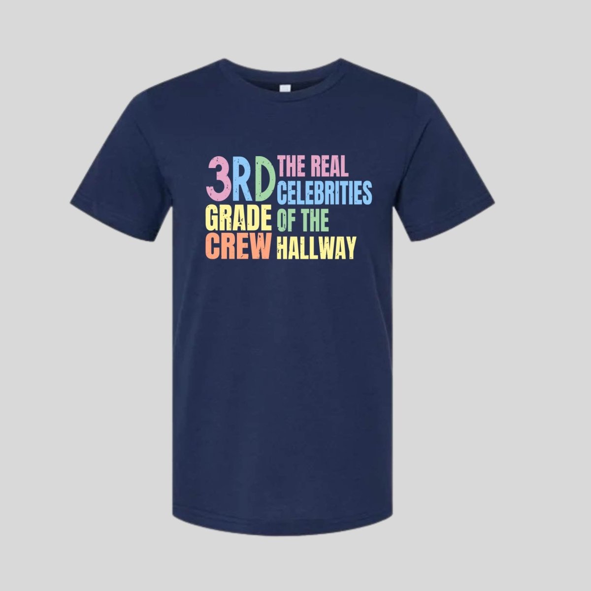 Navy blue t-shirt with colorful text "3rd Grade Crew The Real Celebrities of the Hallway" tshirt on gray background. Little Gift Nook