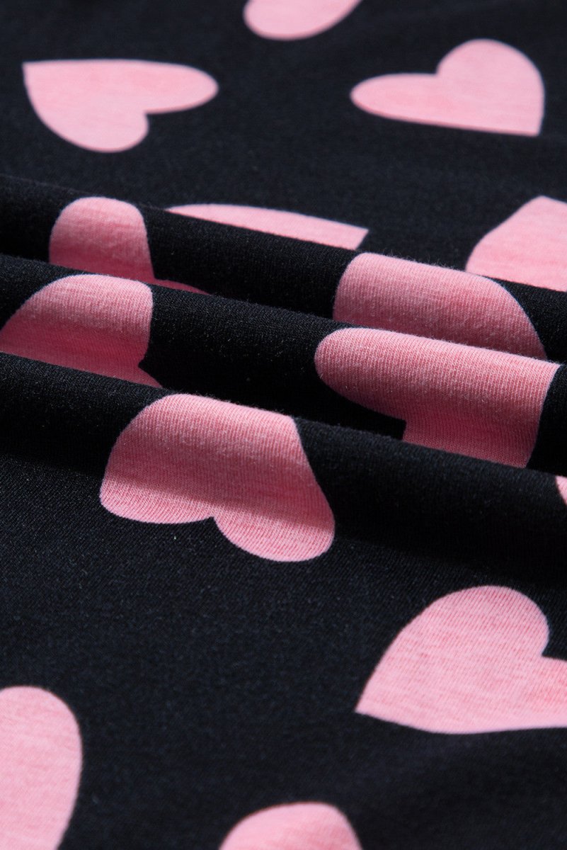 Black Pink Heart Shorts Pajamas set. Black long sleeve top with cuffs and pink heart print all over. Close up of hearts. Black soft shorts, elastic waist, same heart print. Little Gift Nook.