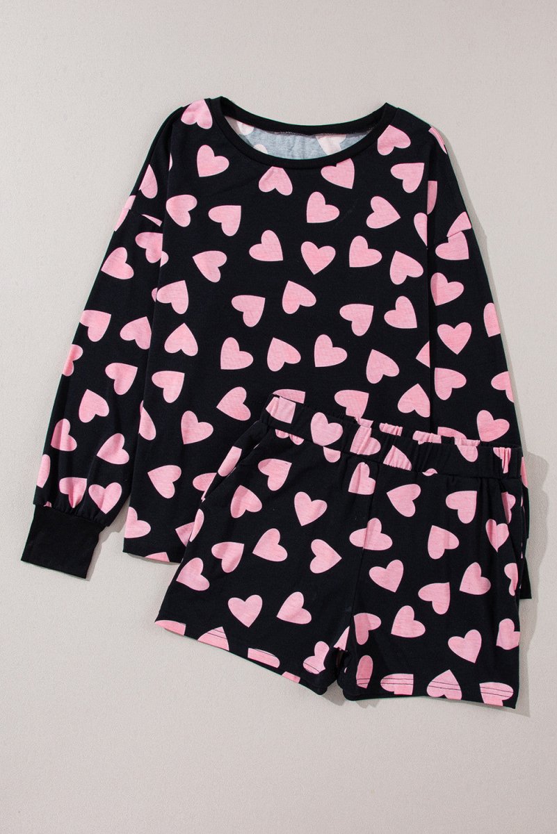 Black Pink Heart Shorts Pajamas set. Black long sleeve top with cuffs and pink heart print all over. Close up ofBlack soft shorts, elastic waist, same heart print. Pajama set layed out flat. Little Gift Nook.