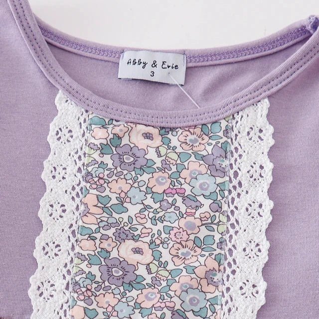 Girl's Lavender Floral Eyelet Ruffle Dress. Eyelet accents & trim. Close up of eyelet and floral print on front of dress. Little Gift Nook.
