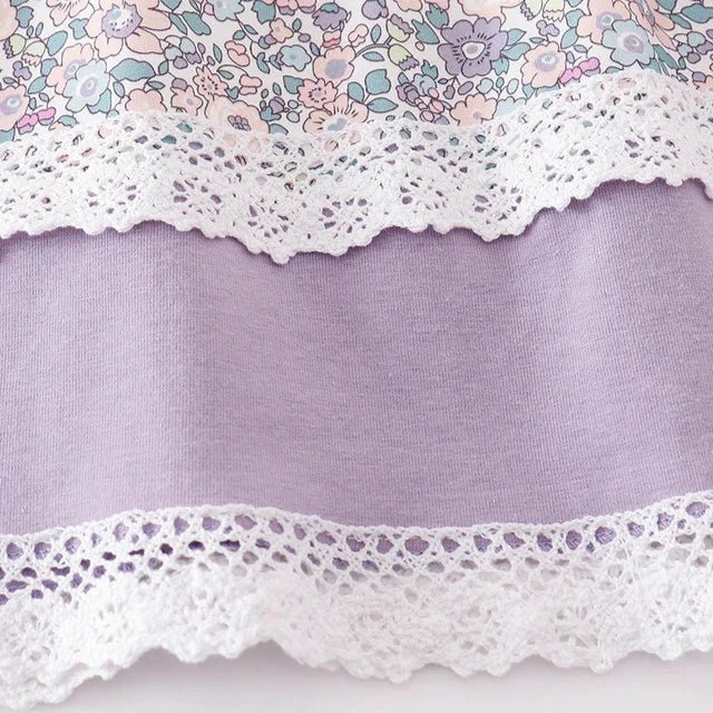 Girl's Lavender Floral Eyelet Ruffle Dress. Eyelet accents & trim. Close up of dress hem with eyelet trim. Little Gift Nook.