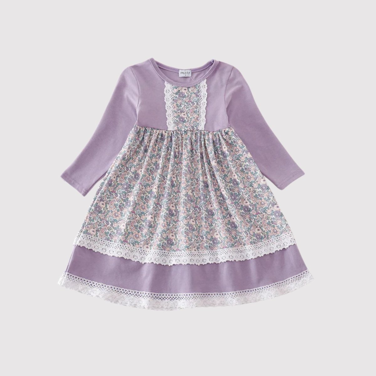 Girl's Lavender Floral Eyelet Ruffle Dress. Lavender light purple dress, long sleeves, with pink, purple, and green floral pattern. Ruffle on chest and eyelet accents & trim. Little Gift Nook.