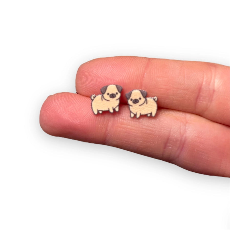 Pug Puppy Earrings being held to see the size. Pretty small studs, perfect for kids. Nickle Free and butterfly stud backing. - Little Gift Nook