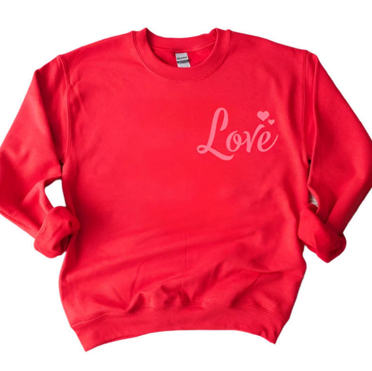 Red Pink LOVE Crewneck Sweatshirt. Red fleece lined unisex crewneck sweatshirt with pink LOVE and hearts at top left. Little Gift Nook.