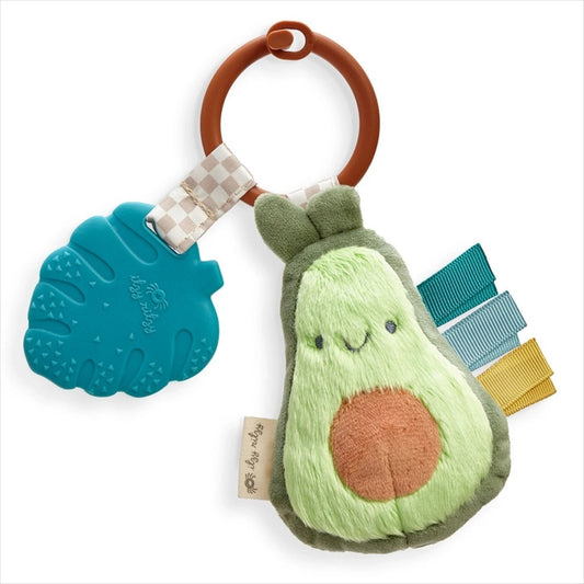 Green avocado plush taggy sensory and silicone teether toy sitting on white background. Little Gift Nook