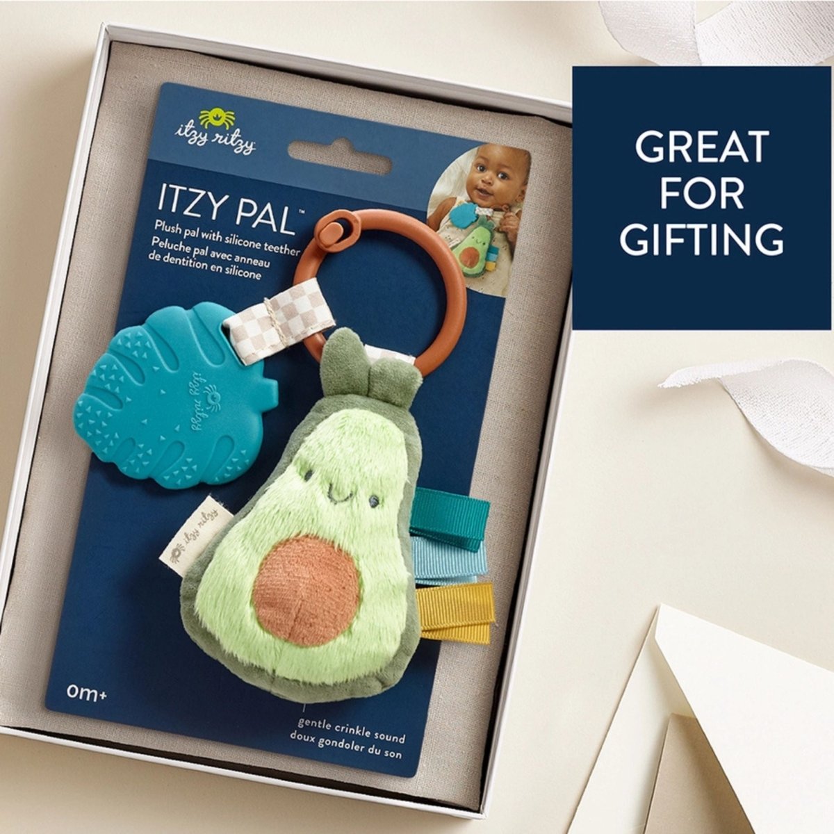 Avocado plush and silicone teether toy for baby in package in box.