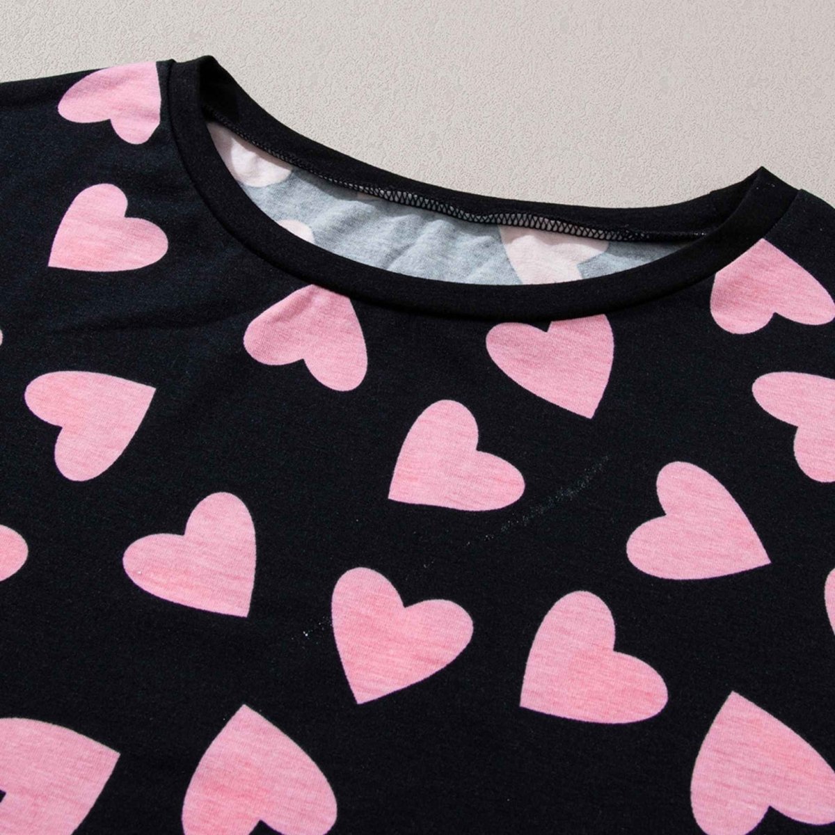 Black Pink Heart Shorts Pajamas set. Top Shorts Lounge Set. Black long sleeve top with cuffs and pink heart print all over. Close up of heart print on top. Black soft shorts, elastic waist, same heart print. Little Gift Nook.