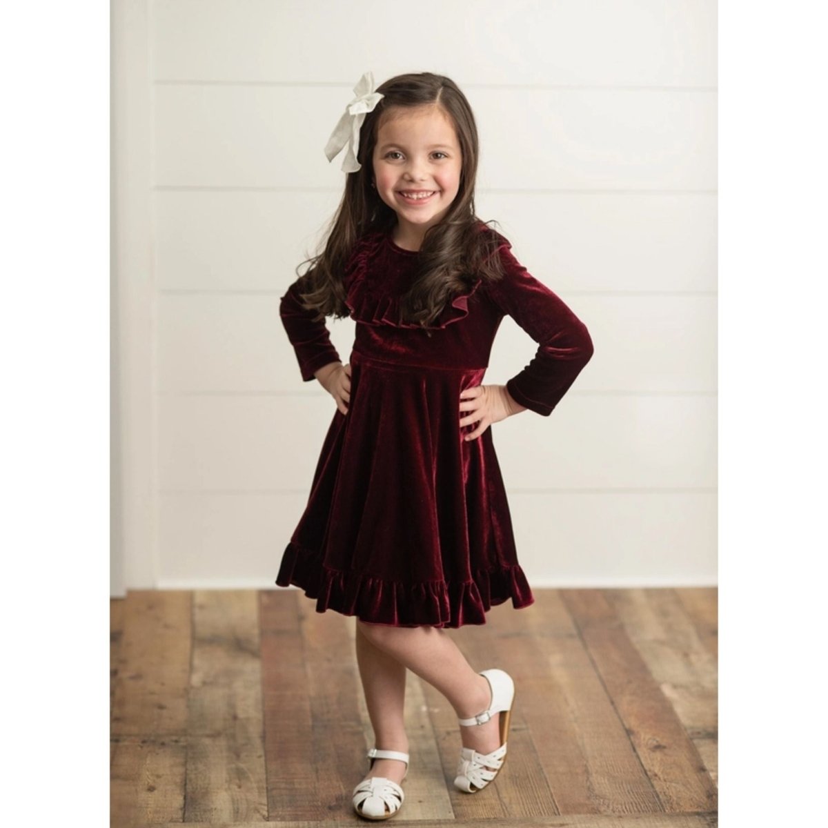 Burgundy Velvet Twirl Holiday Dress. Long Sleeve with ruffles on front. Soft & stretchy. Little Girl modeling dress. Little Gift Nook.
