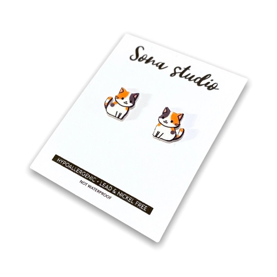calico cat cartoon handmade stud earrings on white card stock. Little Gift Nook.