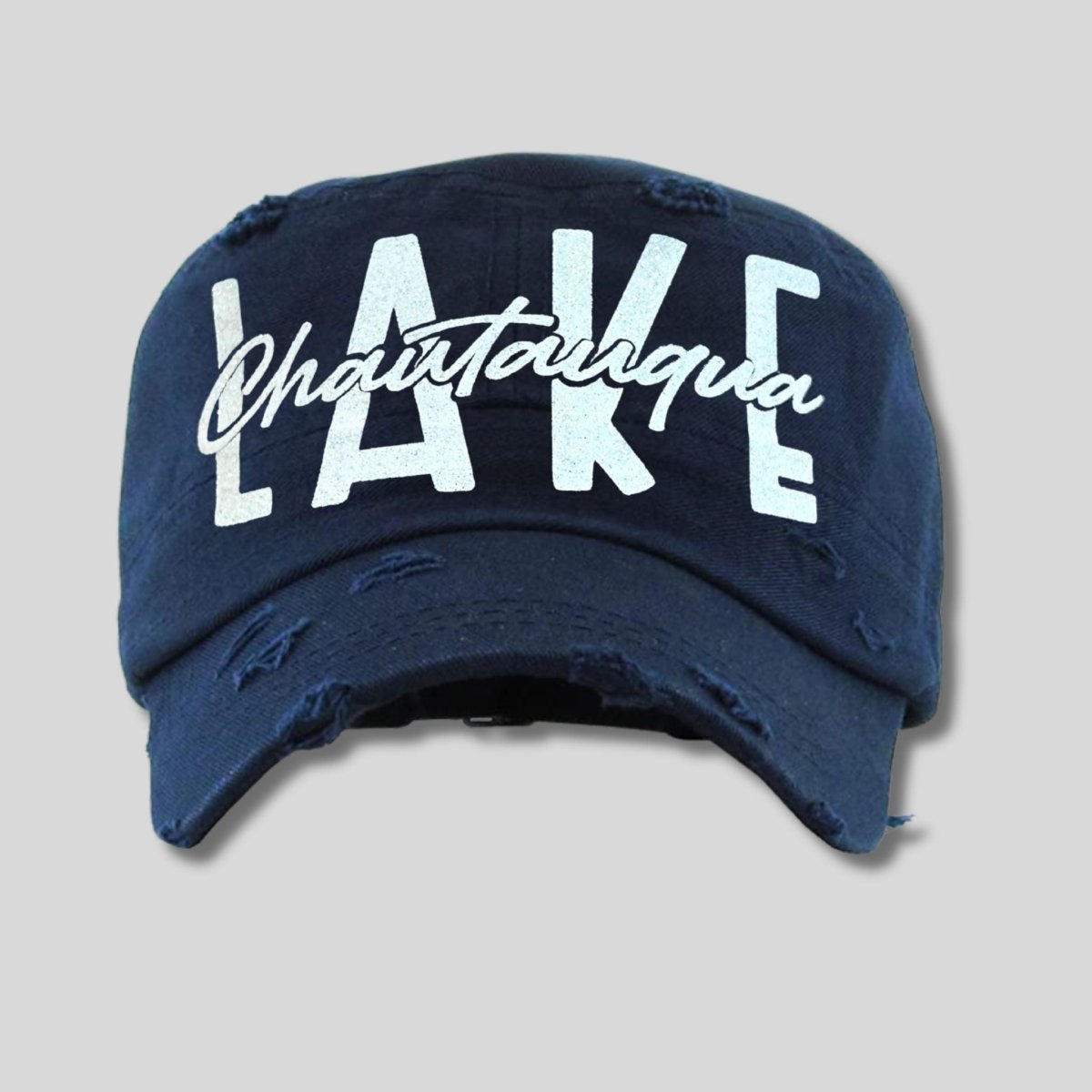Lake Chautauqua navy cadet hat with white glitter font on front on gray background. Little Gift Nook