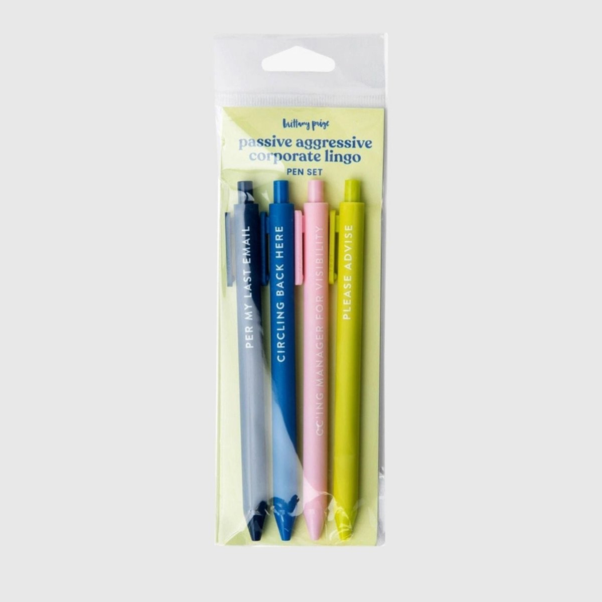 4 colored corporation passive aggressive sayings pen set in package sitting on gray background.