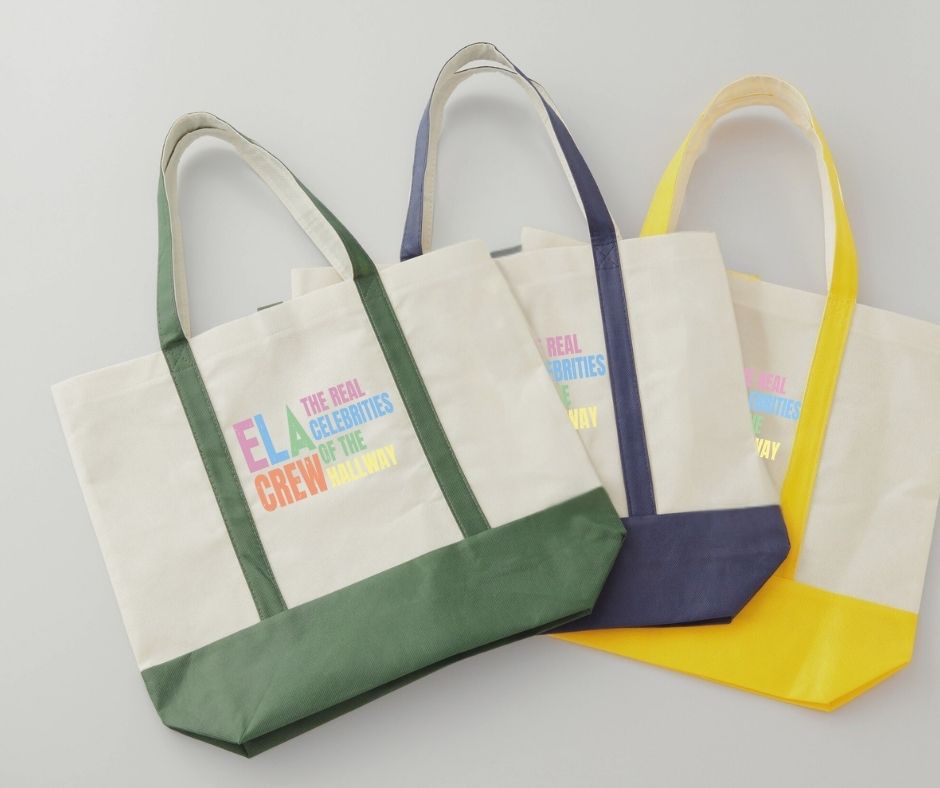 canvas tote bags with colorful digital image with text "ELA Crew. The Real celebrities of the hallway" on front.