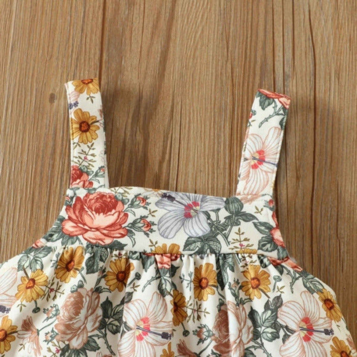 Close up of Floral Baby Girl Jumper Dress Set. Orange, marigold, green, lavender floral print soft & stretchy jumper dress. Little Gift Nook.