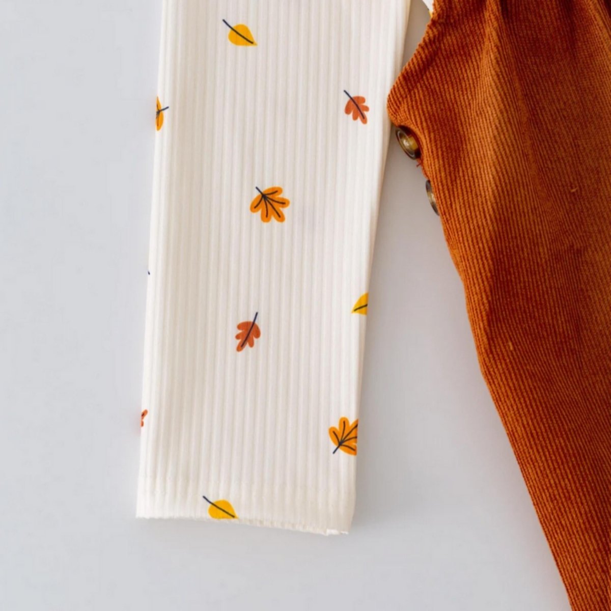 Leaf print cream long sleeve top that goes with the Cute As A Fox Girl's Jumper Dress.