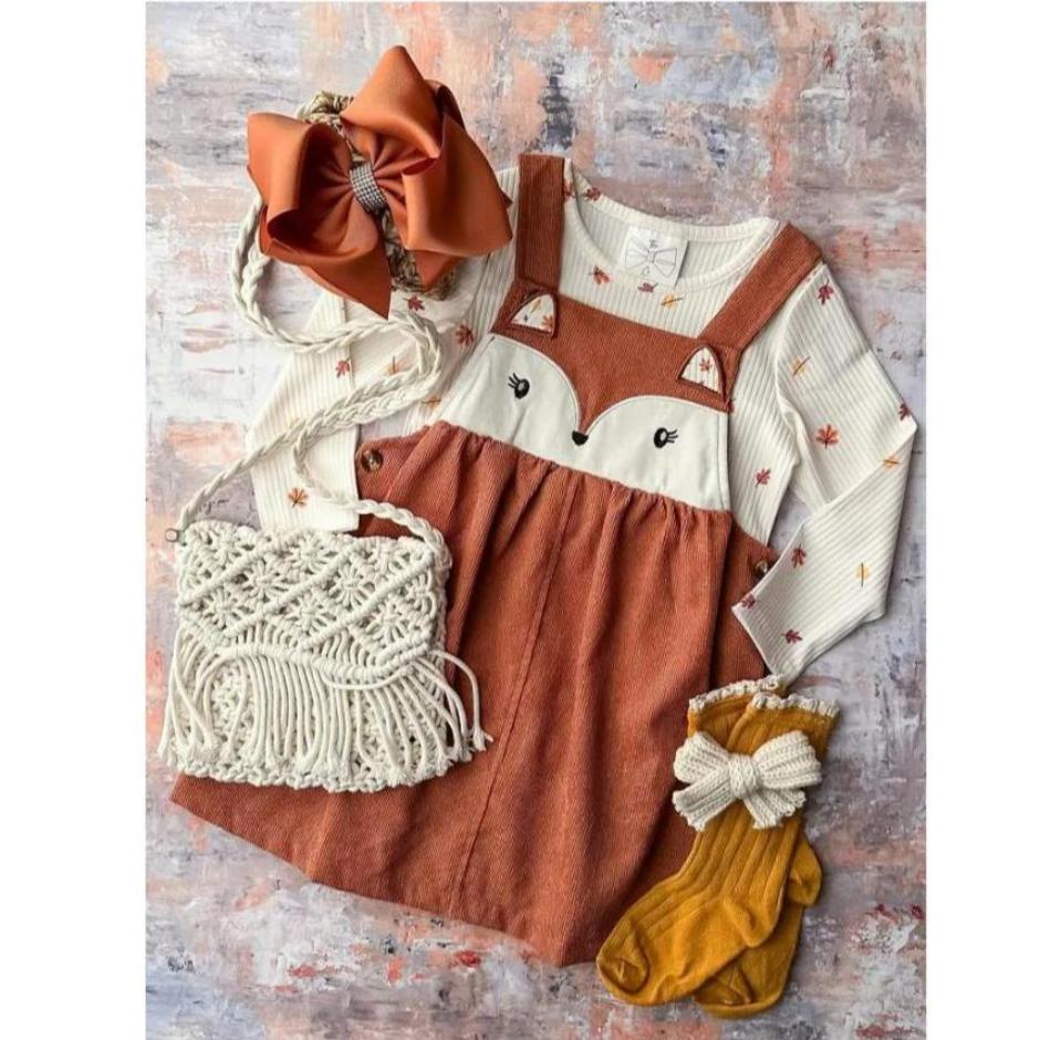 orange fox jumper dress with matching top on colorful background.