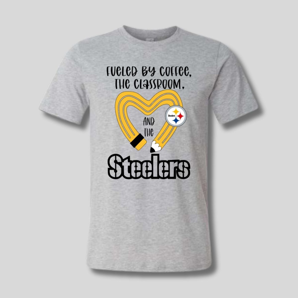 gray tshirt with yellow black pencil heart design and "fueled by coffee, the classroom, and the Steelers" image on front. Little Gift Nook