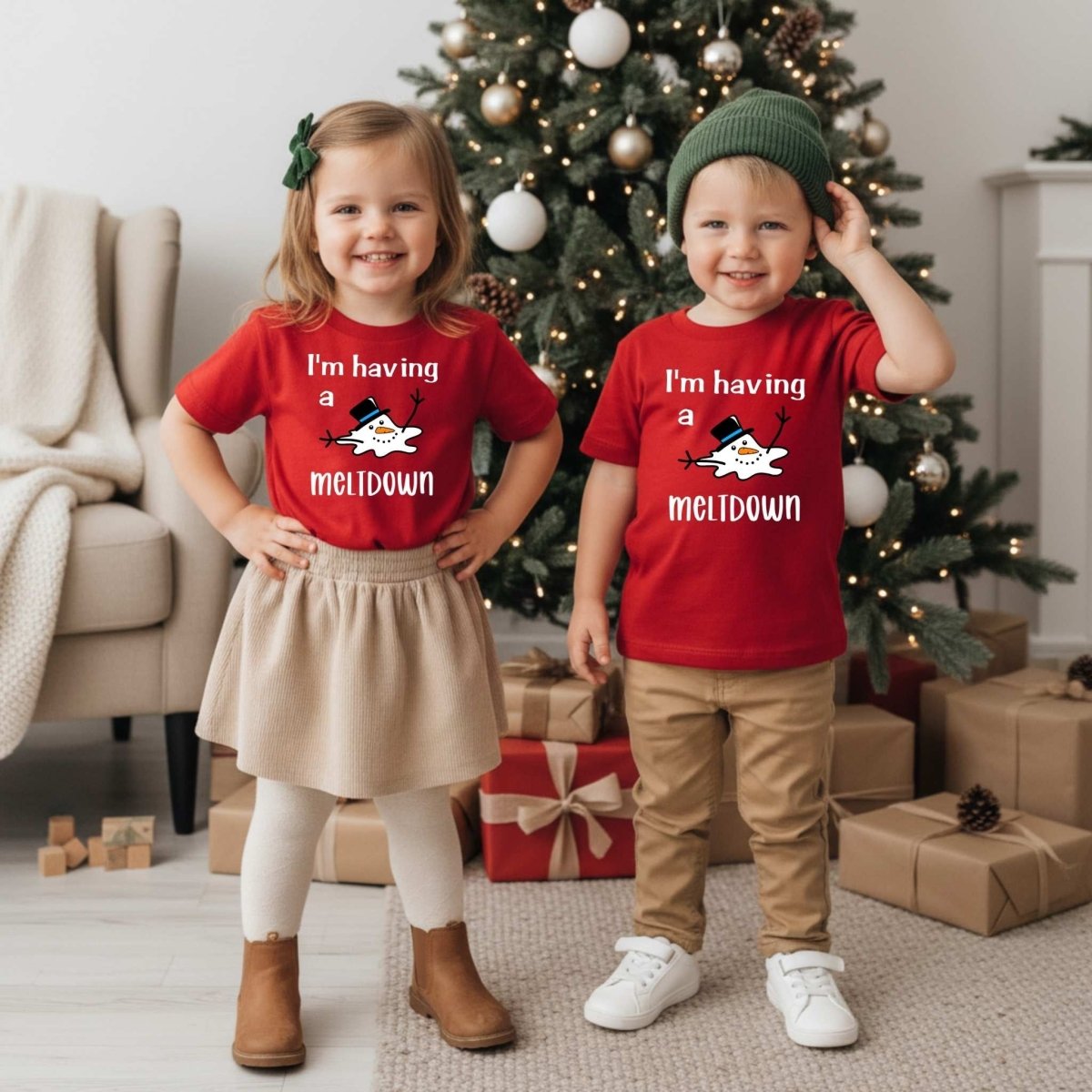 Kids wearing red I'm having a meltdown snowman tshirts standing in front of Christmas tree. Little Gift Nook