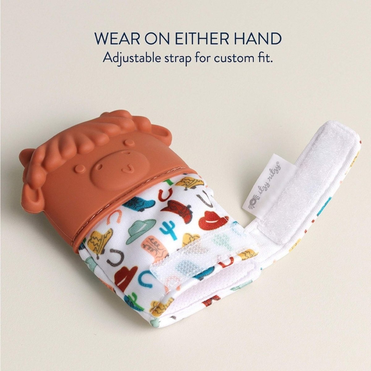Itzy Ritzy brown highland cow teething mitt with velcro closure.