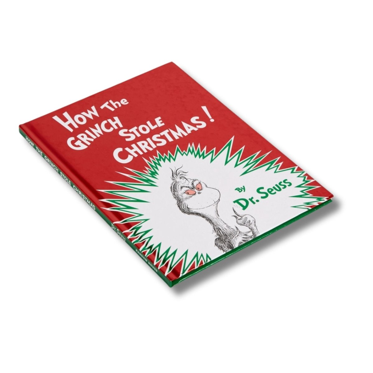 Book titled 'How the Grinch Stole Christmas' by Dr. Seuss laying flat on a white background