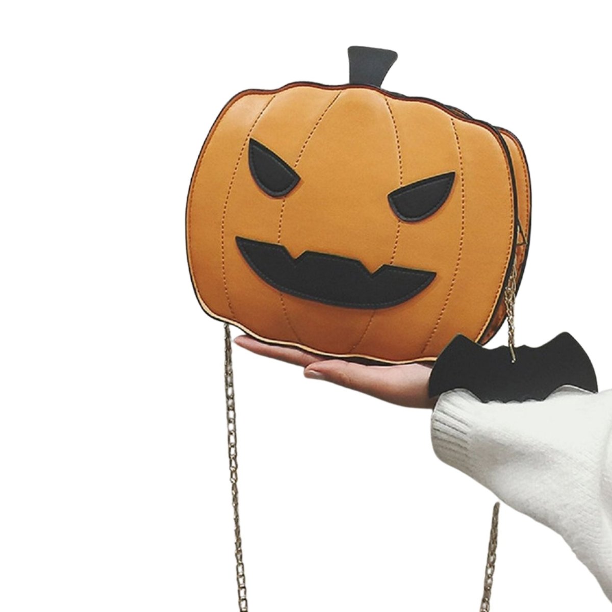 Jack-O-Lantern Pumpkin Purse being held up. Gold metal chain that is detachable. Black bat cloth charm. - Little Gift Nook