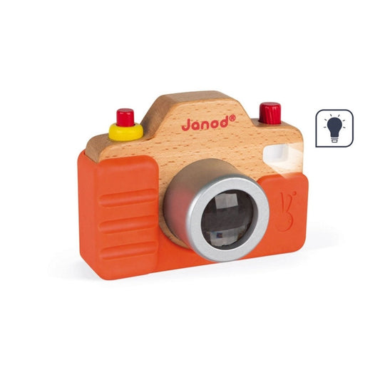 Wooden toy camera with orange silicone case and red buttons on a white background, featuring the Janod brand.