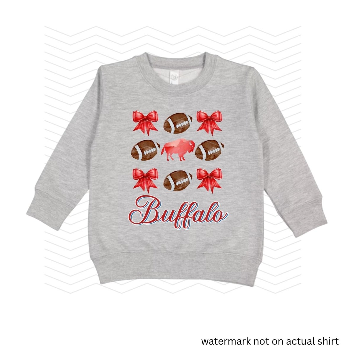heather gray sweatshirt with red bows, buffalo, and brown footballs with the text Buffalo in red and blue cursive below image on front.
