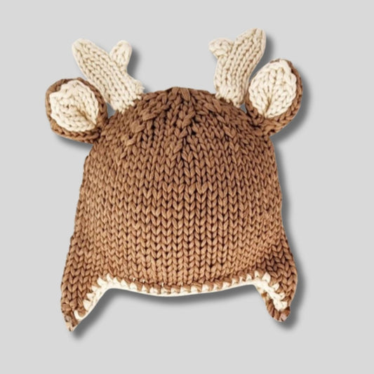 Buck Deer Beanie Knit Baby Hat. Soft yarn and trimmed with adorable antlers and little ear flaps. Cute baby gift. Shown on gray background.  Little Gift Nook.