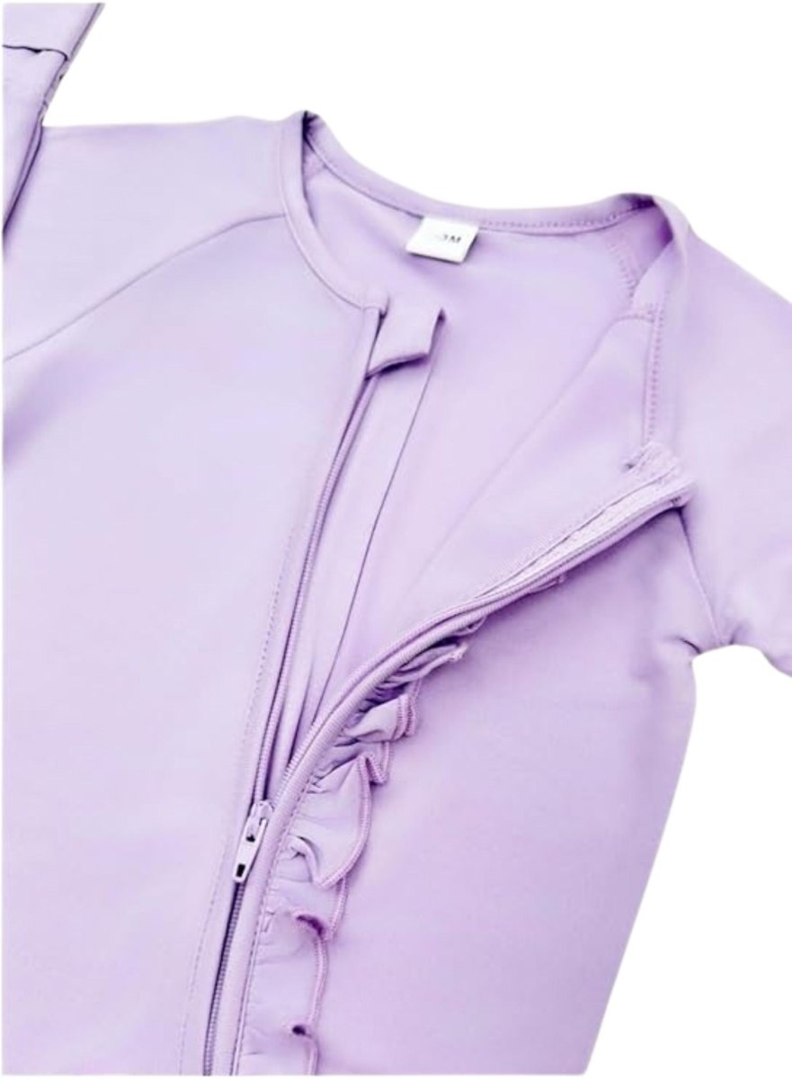 close up of lavender bamboo baby sleeper double zippers and ruffle on front on white background.