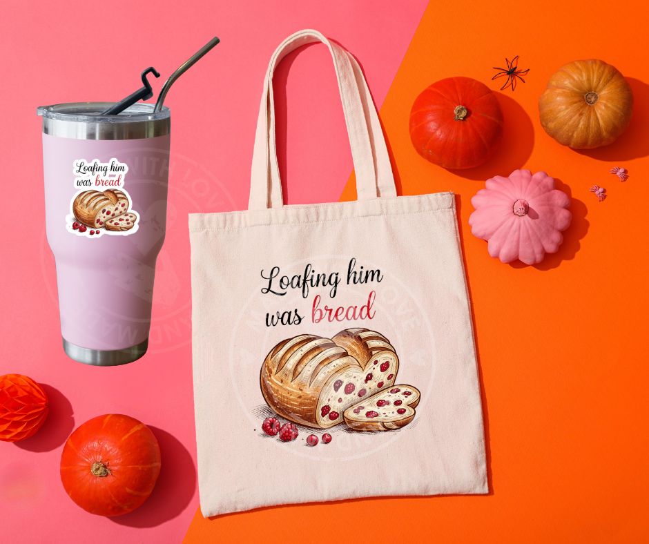pink tumbler and creme tote bag with sourdough loaf shaped like heart with red berries in it and beside it text "loafing him was bread" image on fronts.