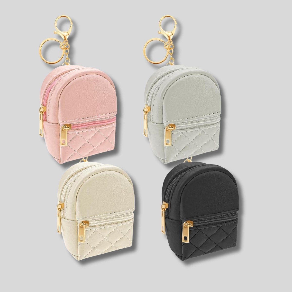 Mini quilted backpack keychains. 2 pockets that open. 4 colors to choose from: pink, gray, cream, or black. Has gold zippers and gold keyring, chain, and lobster cilp. Carry small items like chapstick, money, mints, and more! Little Gift Nook.
