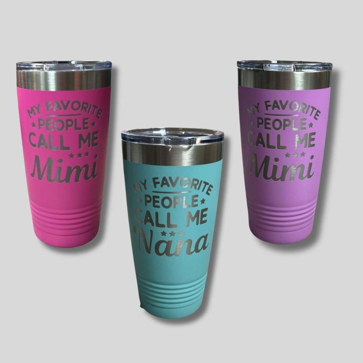 Three tumblers with engraved text "my favorite people call me mimi or nana" on a light gray background