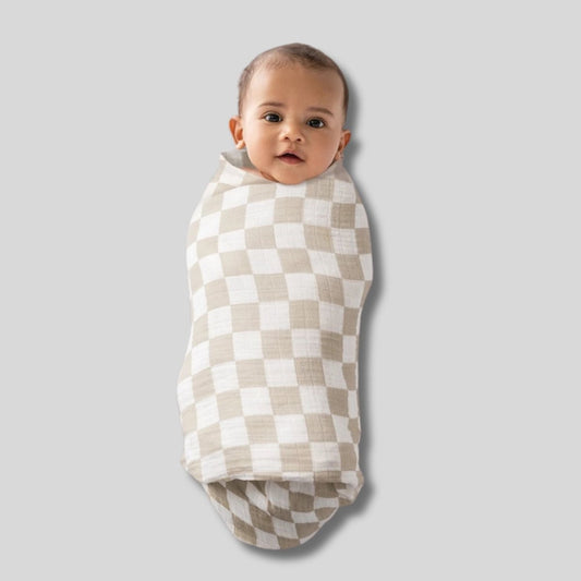 Nursing Cover & Swaddle Blanket in Tan. Tan White checkered pattern. Baby swaddled. - Little Gift Nook