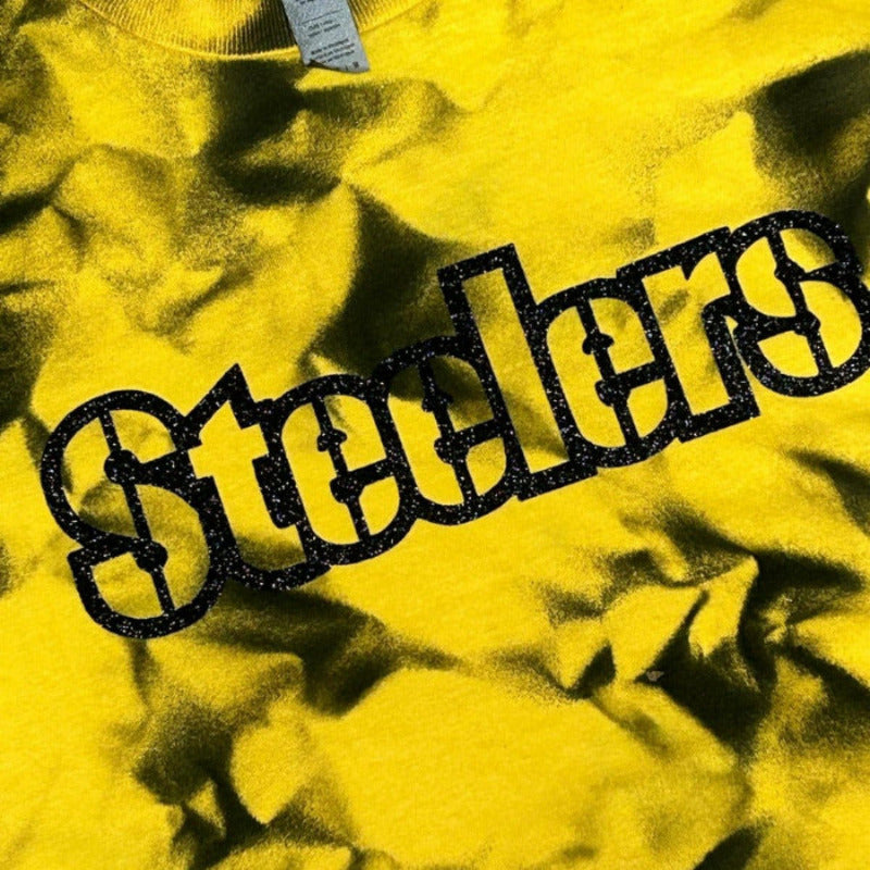 Steelers Black Yellow Dyed Glitter Letter Tshirt. Close up of tie dye shirt with glitter black lettering.