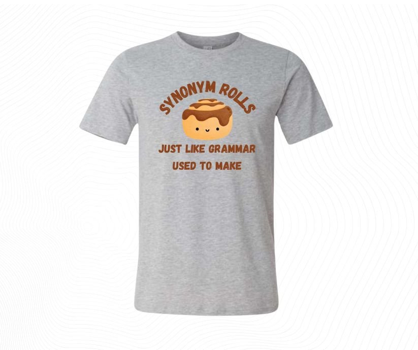 Gray t-shirt with Cartoon cinnamon roll with text 'SYNONYM ROLLS JUST LIKE GRAMMAR USED TO MAKE' image download.