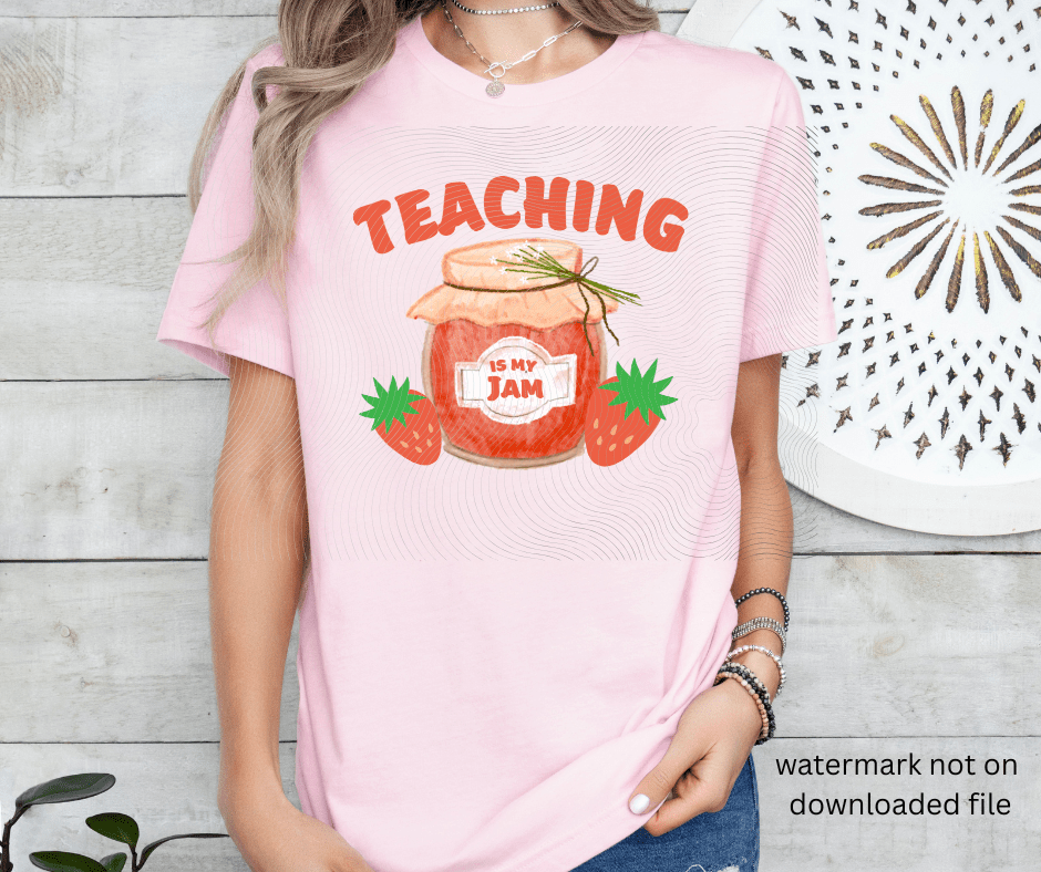 Person wearing a pink t-shirt with 'Teaching is my jam' design standing in front of a wooden background.