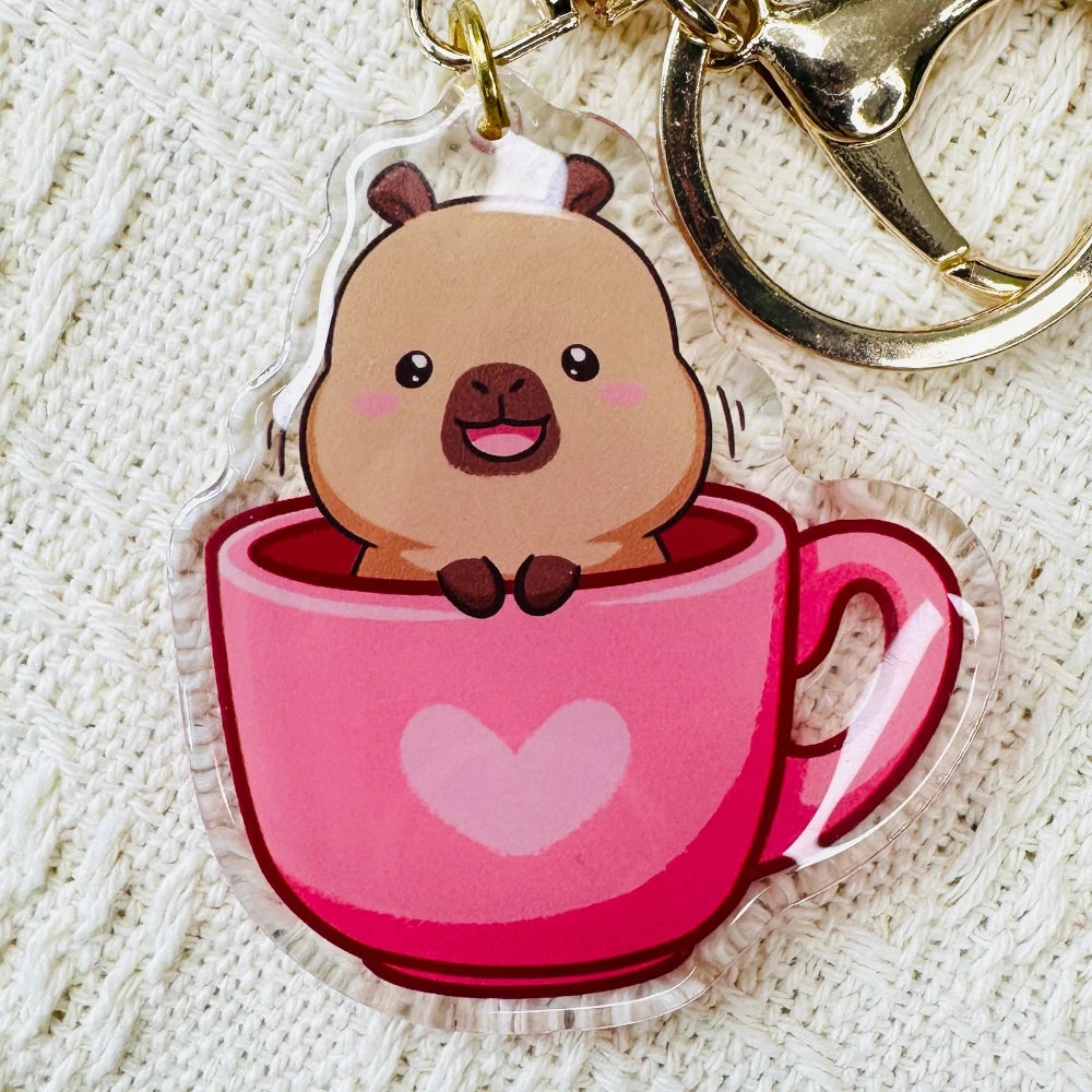 Capybara keychain of cute capybara sitting in pink heart mug. Capybara Acrylic Keychains, double sided. Little Gift Nook.