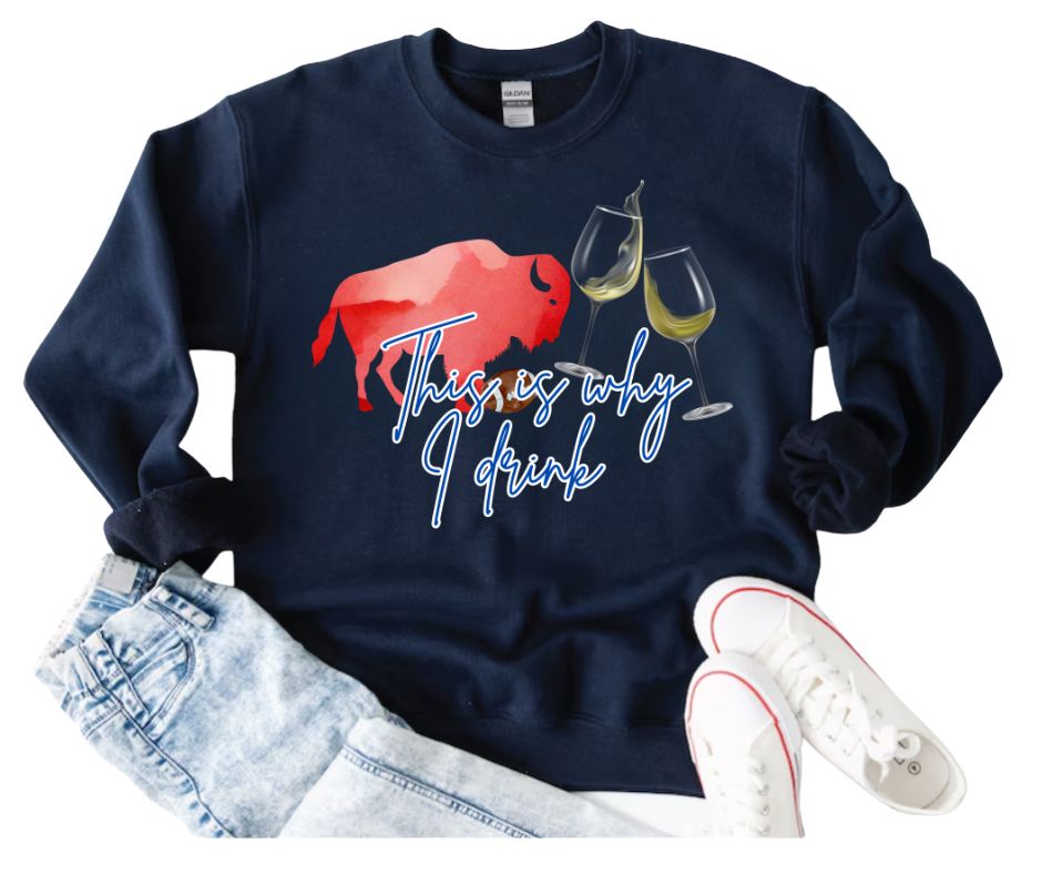 Navy sweatshirt with red buffalo and wine glasses graphic and blue text "This is why I drink" laying on white background with jeans and running shoes. Little Gift Nook