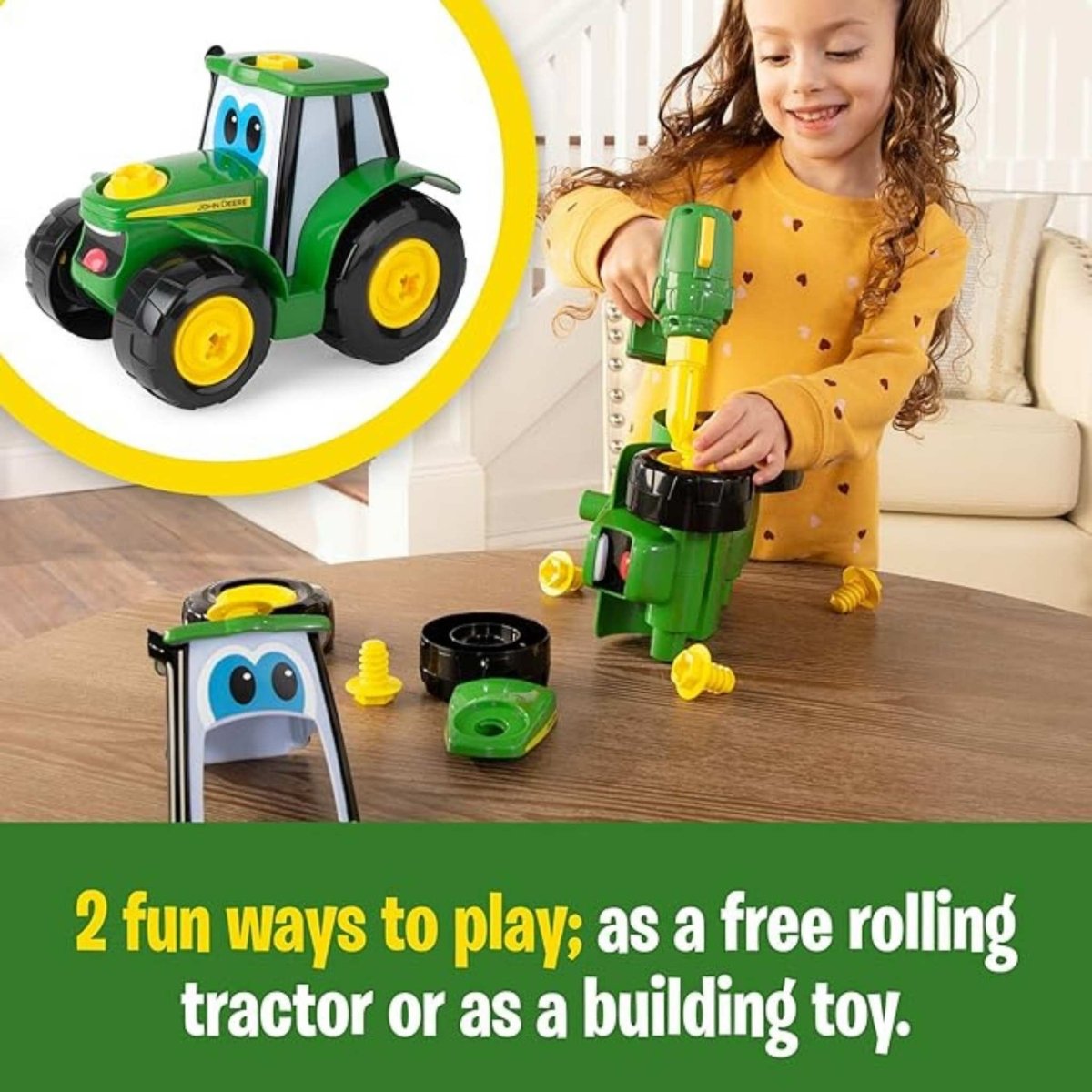 Little girl building a toy plastic John Deere tractor toy with toy drill on brown table top.