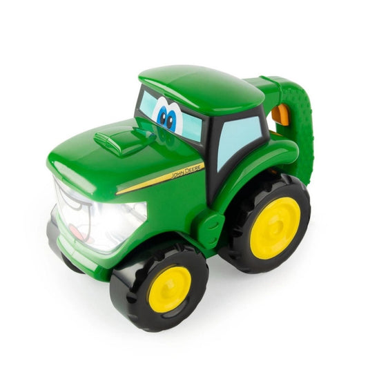 TOMY John Deere mini tractor flashlight toy sitting on white background. Little Gift Nook