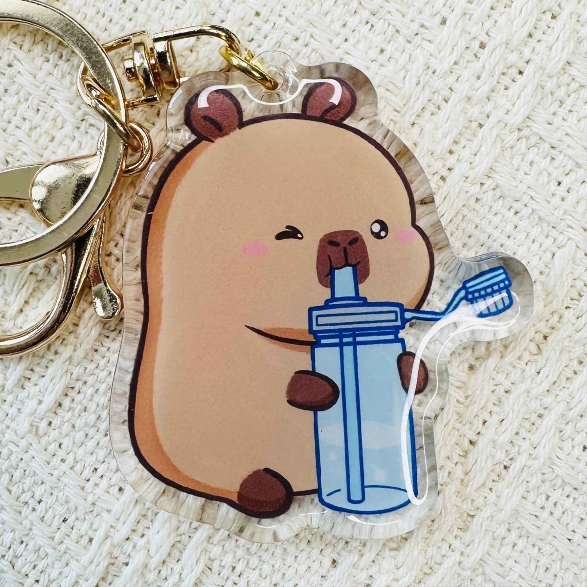 Capybara holding water bottle Acrylic Keychains. Double sided. Comes with metal keyring and hook. Little Gift Nook.