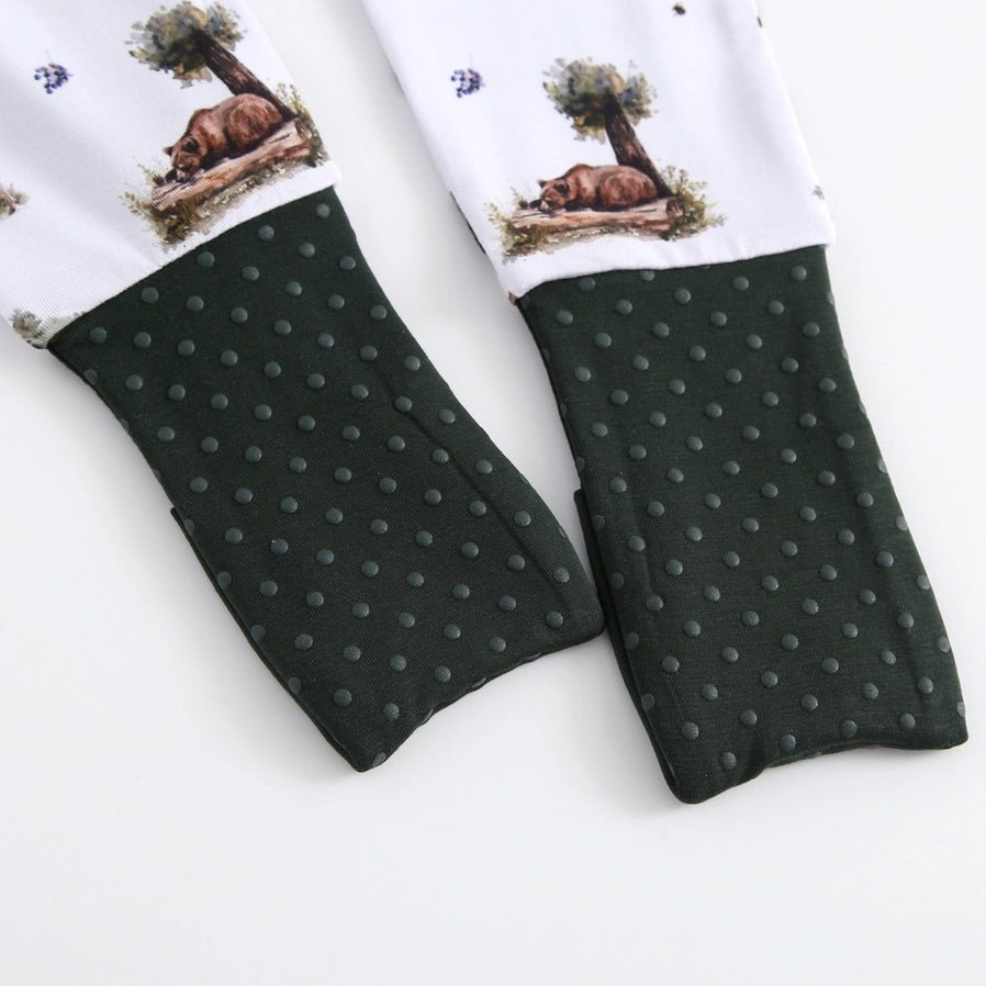 Baby bamboo white and forest green baby sleeper with fold over feet close up.