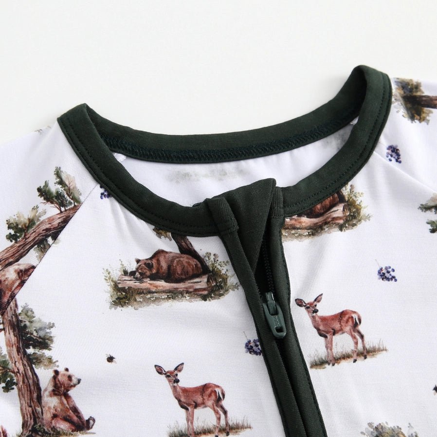 close up of neckline and zippers on white green bamboo woodland animal baby sleeper.