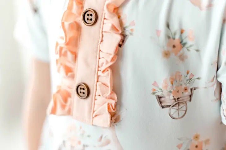 Honey Bunny Blue Eyelet Twirl Dress. Close up of front of dress floral print and ruffle accents. - Little Gift Nook