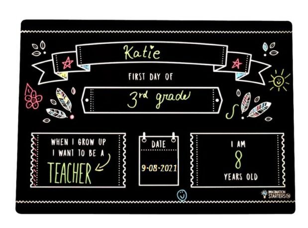 Imagination Starters black plastic wipe off First Day of School Grade filled out placemat board sitting on a white background.