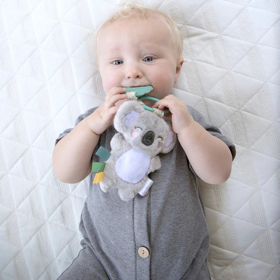 Baby holding teether and plush Itzy Ritzy Itzy Pal™ Koala Plush + Teether - Little Gift Nook