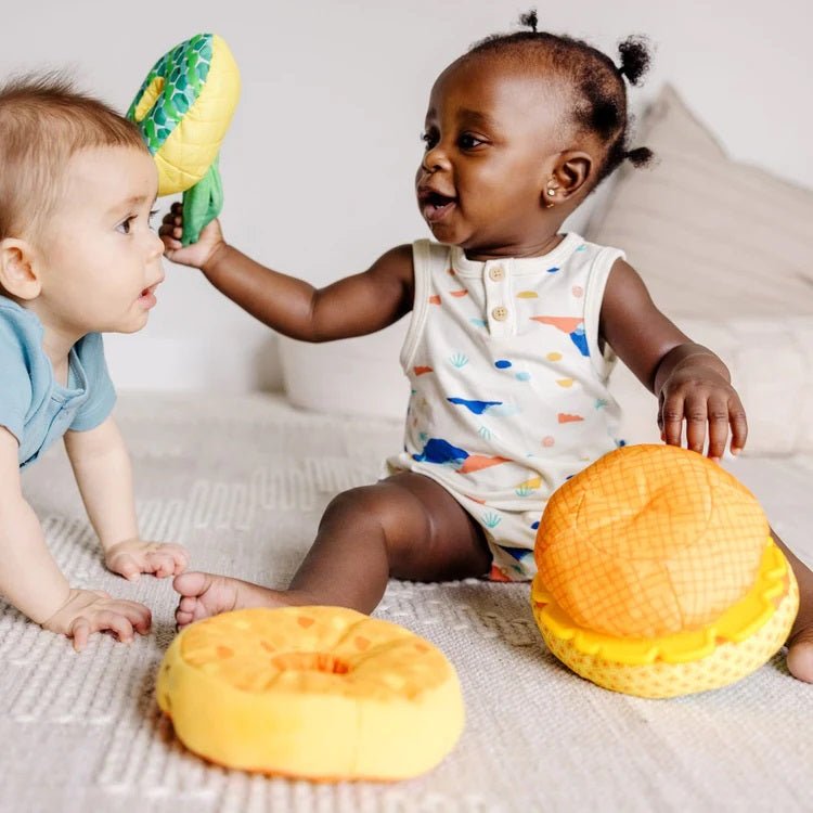 Melissa & Doug Pineapple Soft Stacker for baby. 2 babies playing with soft stacker pieces. - Little Gift Nook