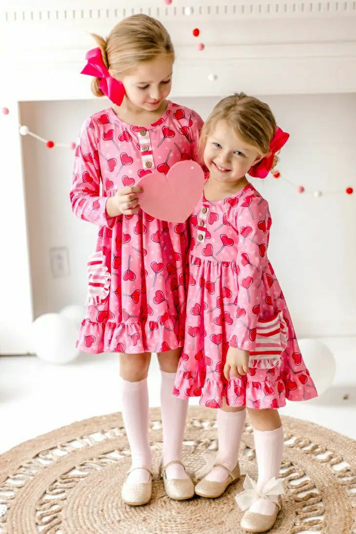 Sucker for Love Hearts Ruffle Twirl Dress. 2 girls in these adorable pink heart sucker print ruffle dresses. - Little Gift Nook