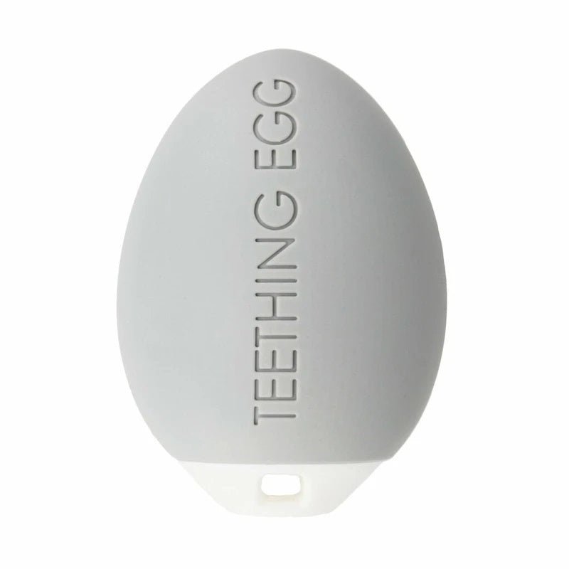 Close up of The Teething Egg Baby Teether in Gray. Soothes top and bottom gums, is a rattle, and Made in USA. - Little Gift Nook