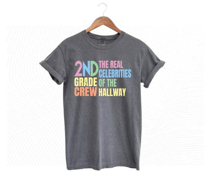 Gray tshirt with colorful digital image with text "2nd grade crew. The Real celebrities of the hallway" on front.