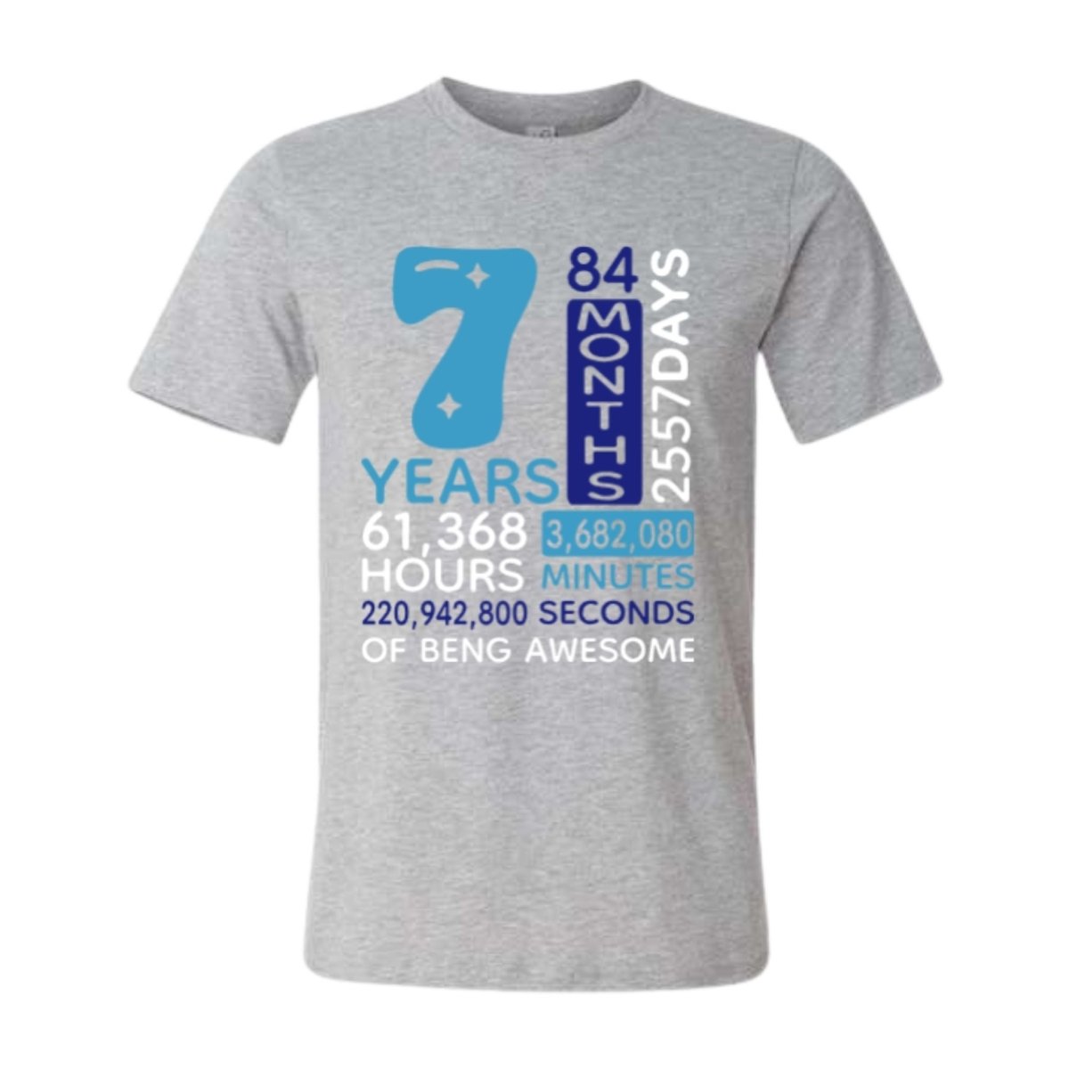 Gray t-shirt with blue and white text counting days, hours, minutes, and seconds of being 7 years awesome laying on a white background.